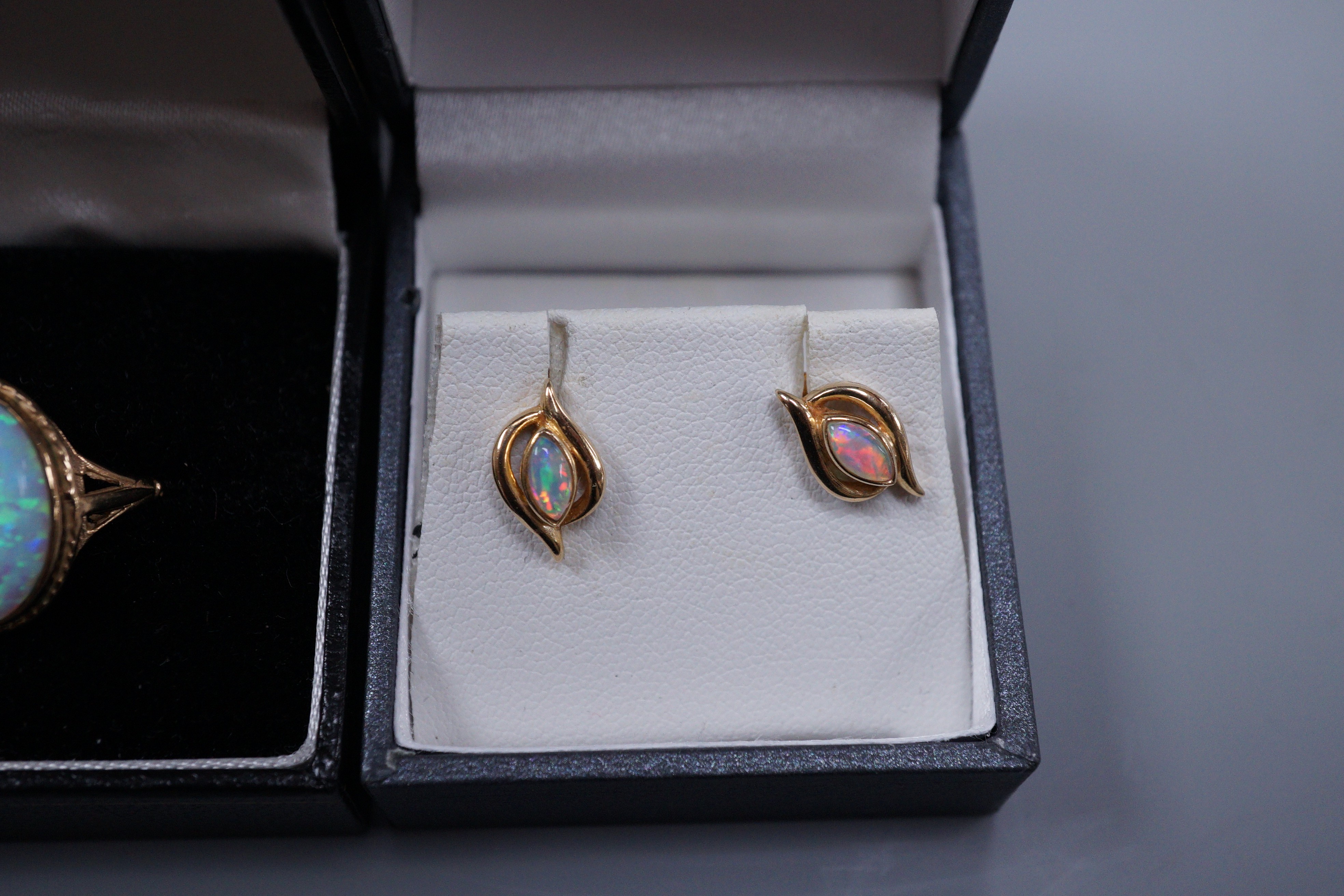 A 9ct gold white opal doublet ring, size O and a pair of white opal mounted ear studs